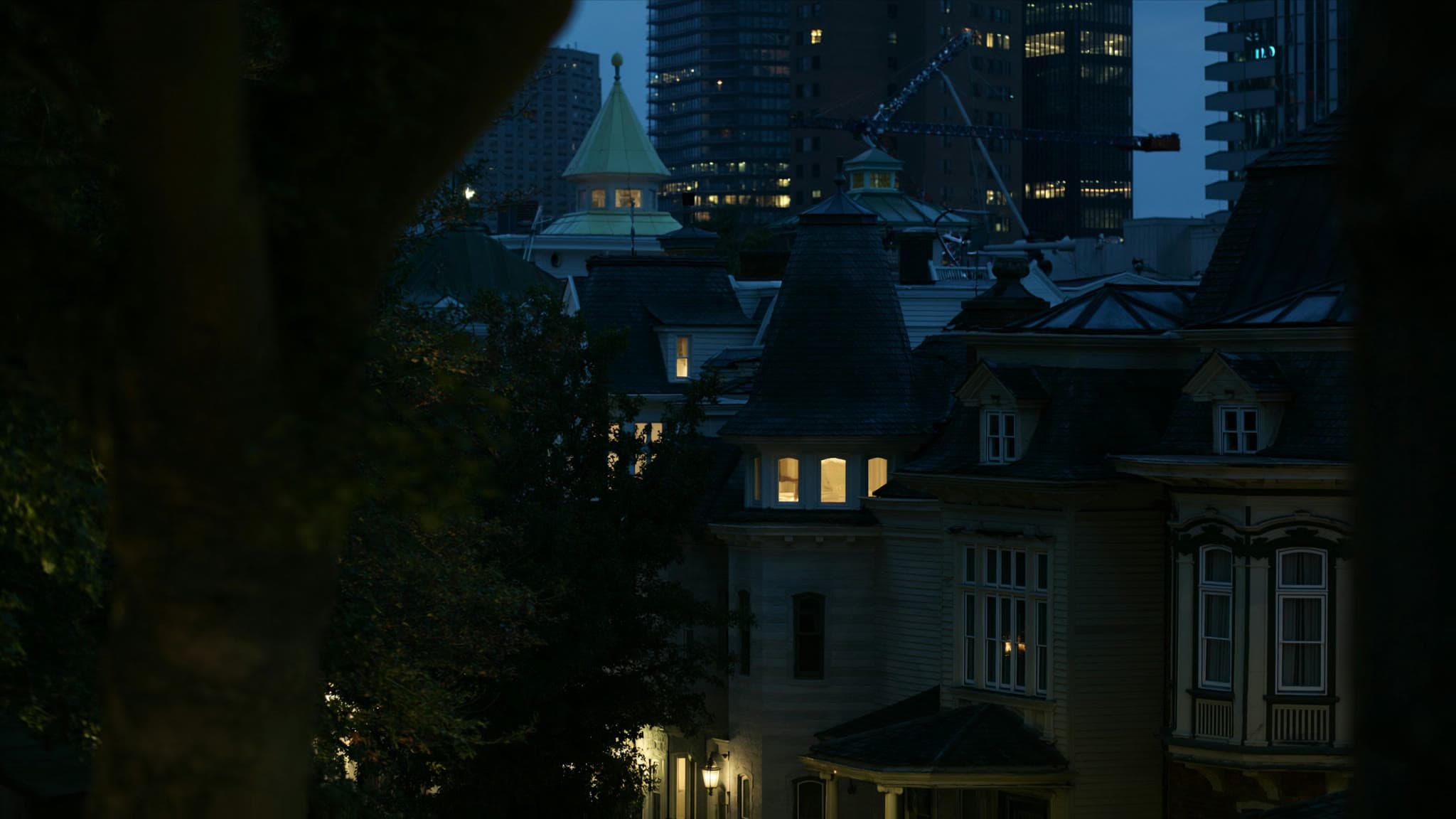 Cambridge at dusk: stylized artwork of mansard-roof houses with Kendall Square beyond, not a photograph
