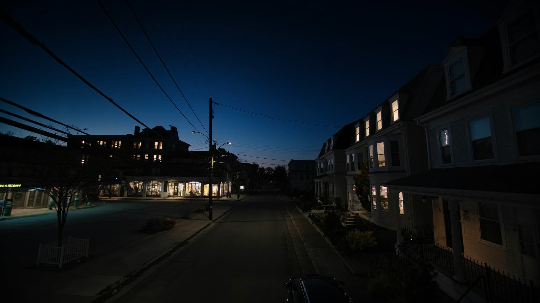 Somerville at dusk: stylized artwork of triple-deckers and Davis Square, not a photograph