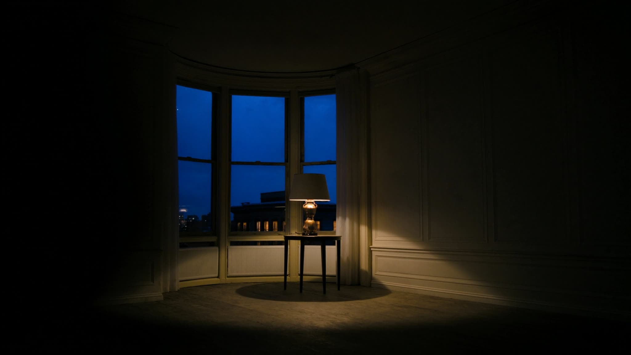 Stylized brand artwork of an empty brownstone parlor at dusk, lamplight in the bay window